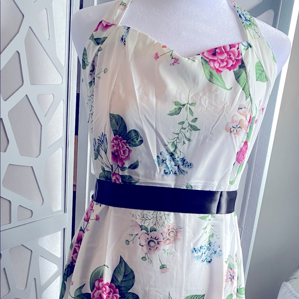 New.  White floral dress, ties behind neck.